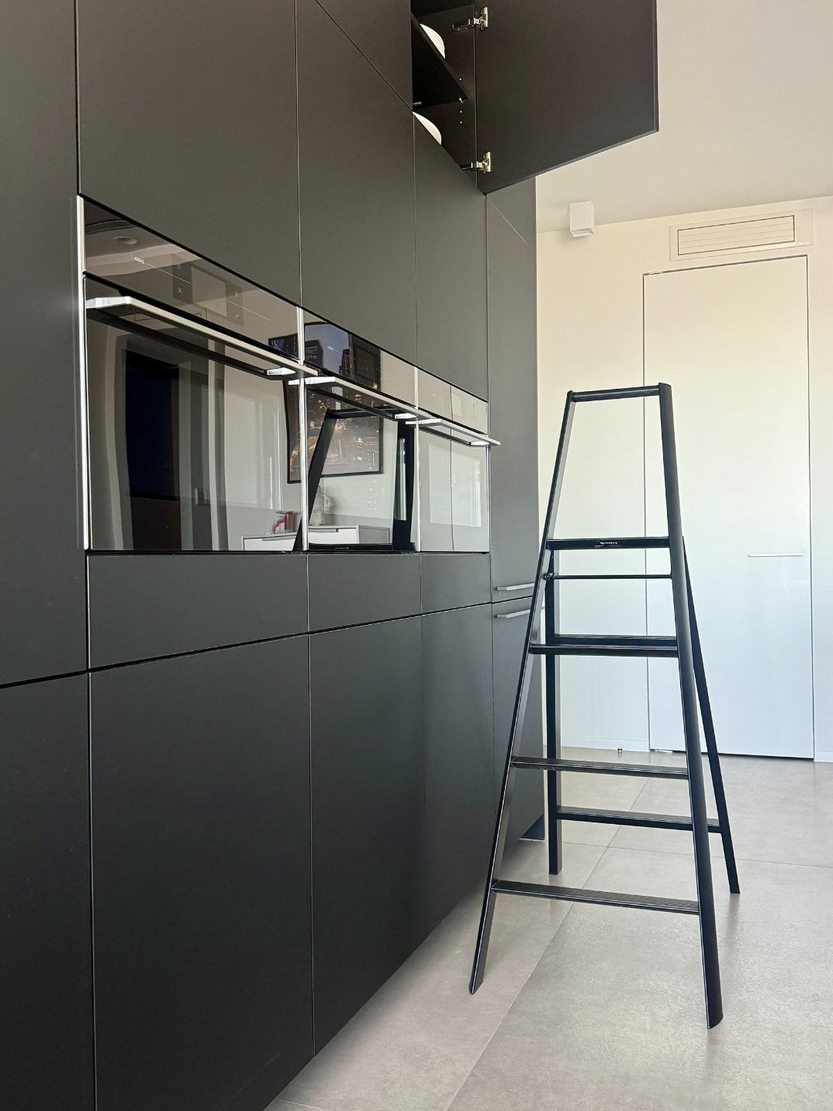Hasegawa Lucano 4 Step trapladder in Zwart in een interieur